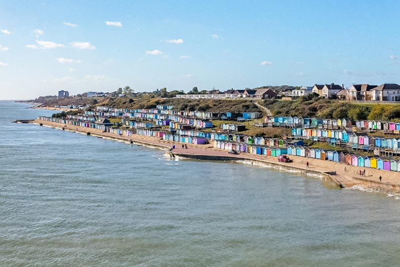 Colourful beach huts lining the shore at Walton-on-the-Naze in Essex