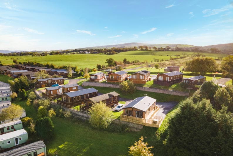 Lodges set amongst rolling green hills at Todber Valley Holdiay Park in the Lancashire countryside