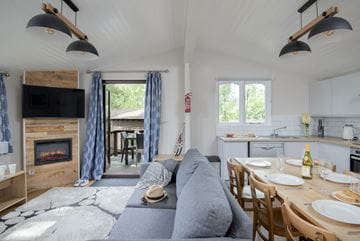 The lounge and dining area inside a stylish lodge at Parkdean Resorts