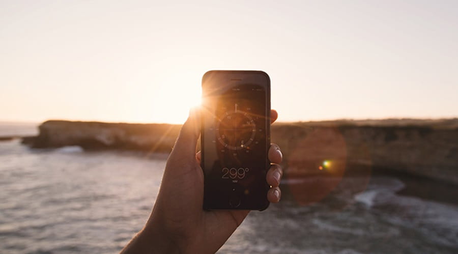 Holding mobile phone up in sunshine