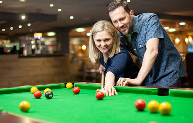 A couple playing pool