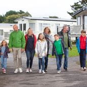 Family walking hand in hand through Parkdean Resorts