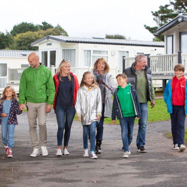 Family walking hand in hand through Parkdean Resorts