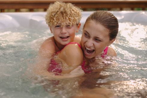 Mum and son in hot tub