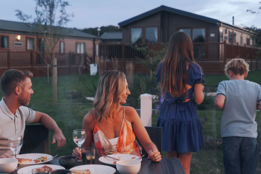 Couple sat on veranda watching their children looking at the view