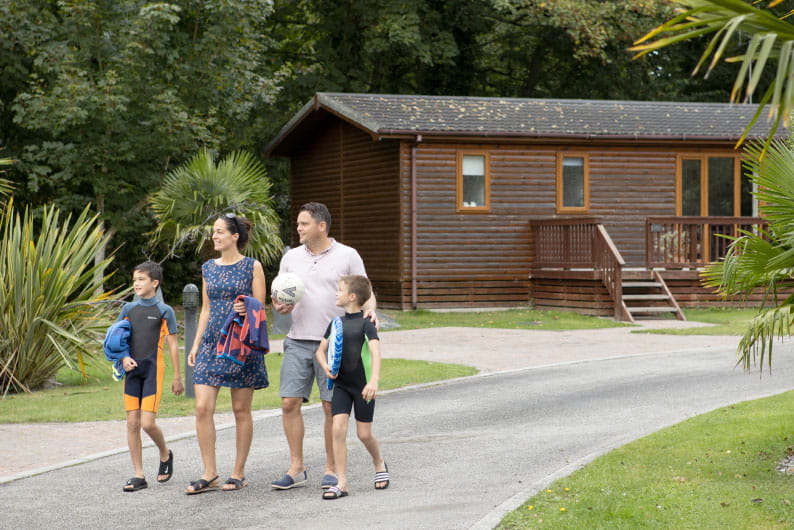 Family walking hand in hand through Parkdean Resorts
