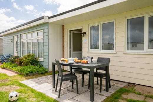 Holiday chalets with an outside seating area at a Parkdean Resorts holiday park
