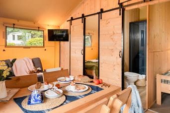 Inside the living and dining area of a Parkdean Resorts safari glamping tent