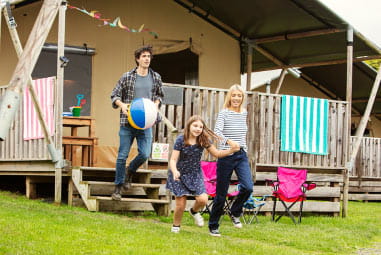 A family heading out from their glamping tent at Thorness Bay Holiday Park