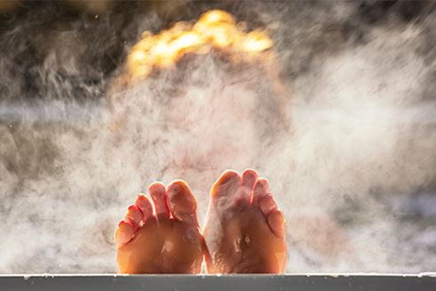 A person floating in a hot tub and relaxing