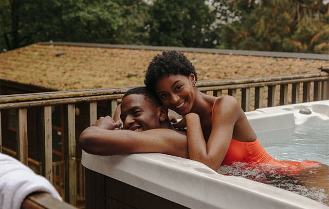A couple relaxing in their lodge hot tub