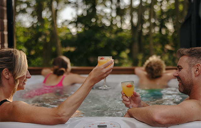 A family relaxing in their lodge hot tub