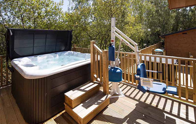 An accessible hot tub with a hoist for people who use wheelchairs