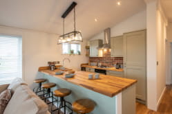 A stylish kitchen and island inside a holiday lodge