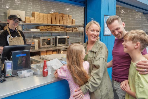 Family queuing for fish and chips at Parkdean Resorts