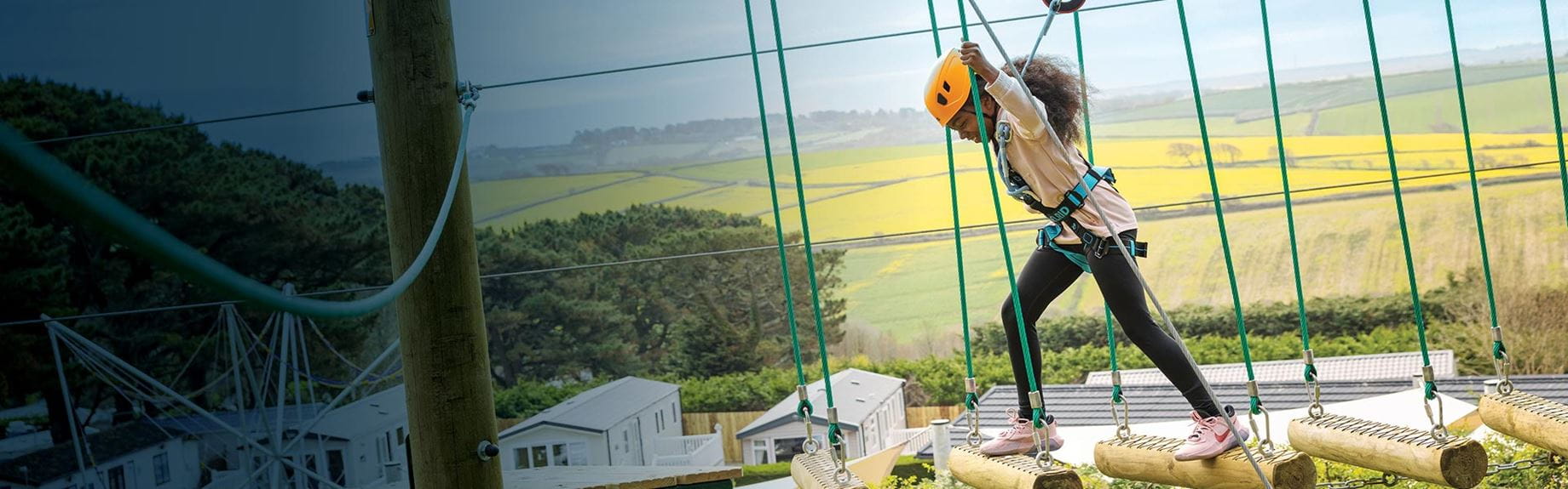 Girl completing high ropes course at Parkdean Resorts
