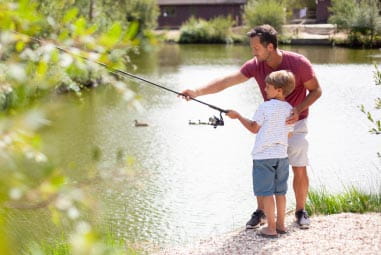 a father and son fishing in a lake
