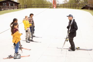 an instructor with a group on the ski slope