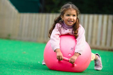 child on a bouncy ball 