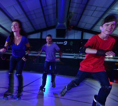 A family zooming along at the roller disco