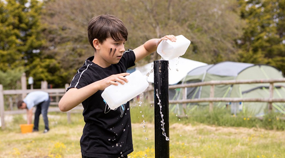 A boy collecting water at BGSA