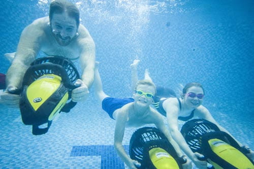 Family underwater with an aqua jet