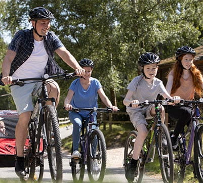 family all riding bicycles
