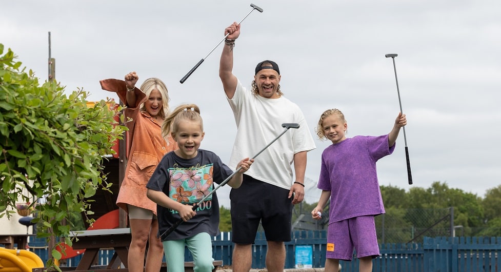 family playing mini golf