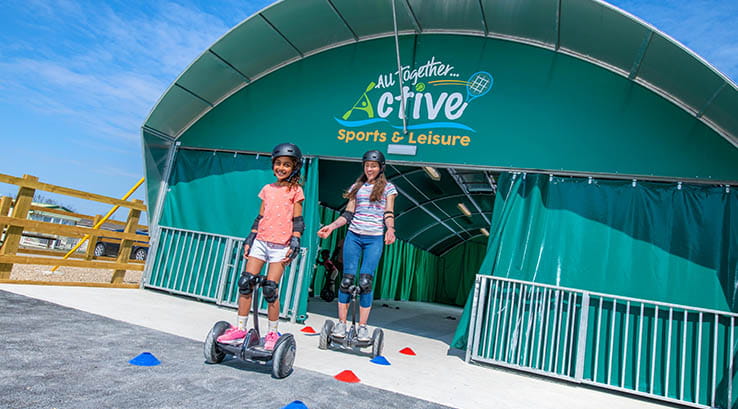 family on Hoverboards coming from the sports dome