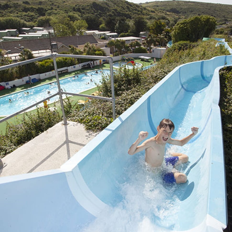Waterslide and outdoor pool at Holywell Bay Holiday Park