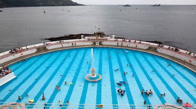 A large outdoor swimming pool by the sea