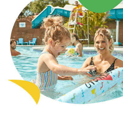 A mother and daughter enjoying an outdoor pool in the sun