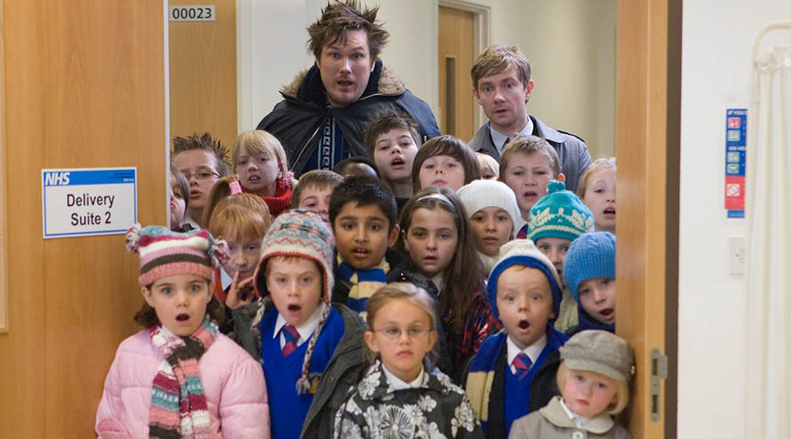 Children in school uniform stood in a door way looking surprised