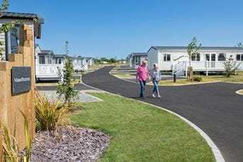 Couple walking by caravans