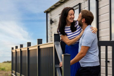 Couple outside caravan