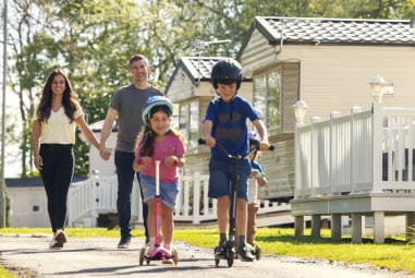 Family outside caravans
