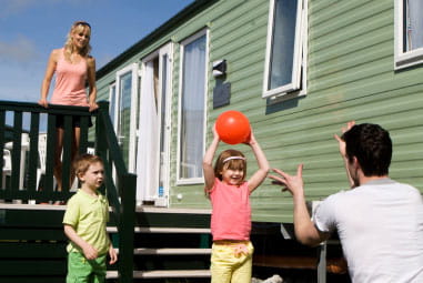 Family outside caravan