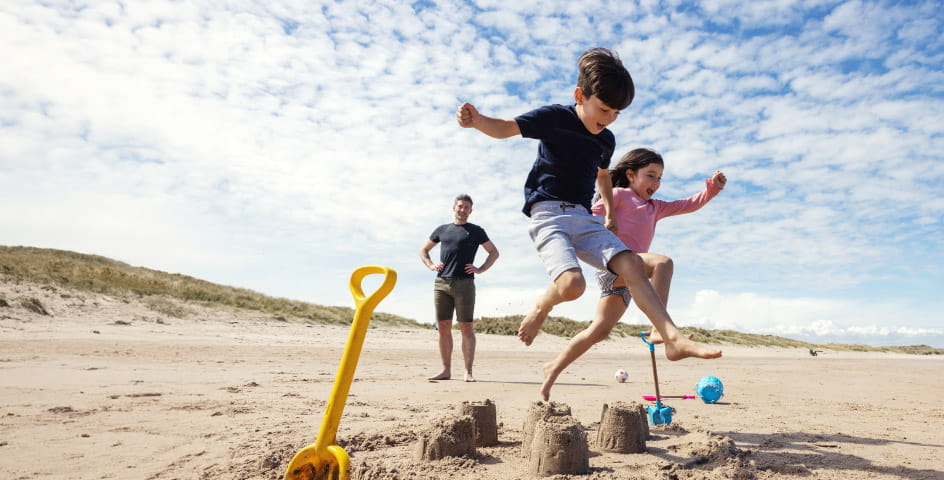 Kids jumping on beach