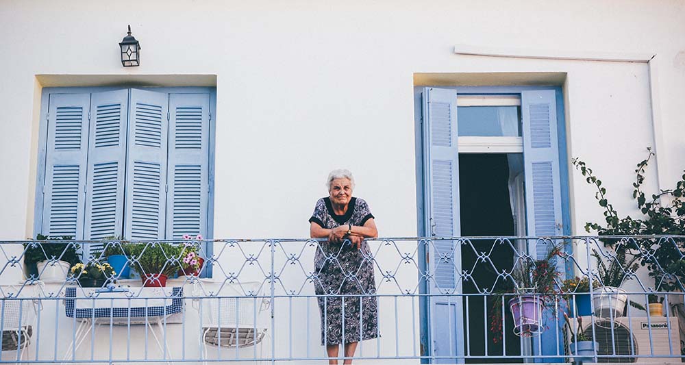 A women standing on the balcony of her european apartment