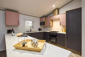 kitchen in Willerby Boston lodge, clean and modern with pink and grey accents