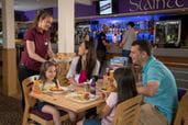 Family sat at a table eating and drinking