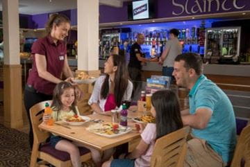 Family sat at a table eating and drinking