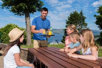Family sat at a table eating and drinking