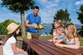 Family sat at a table eating and drinking