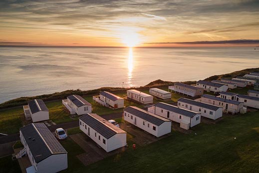 Caravans with the sea and sunset