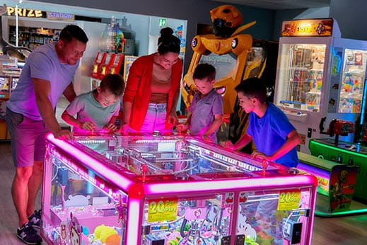 Family playing games at the arcades