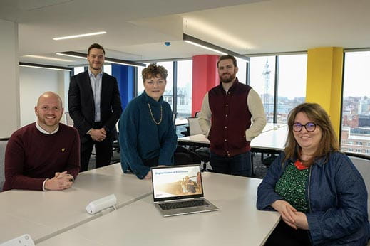 Group of people smiling in the Parkdean Resorts Leeds city centre office