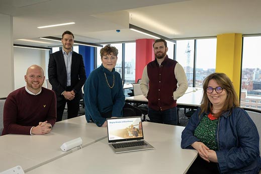 Group of people smiling in the Parkdean Resorts Leeds city centre office