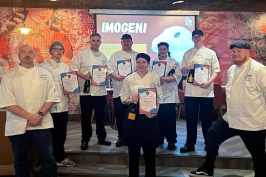 Group of chefs smiling for the camera holding certificates