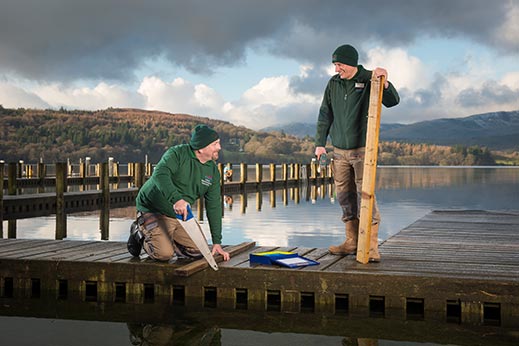 Two older holiday park employees working on maintenance 